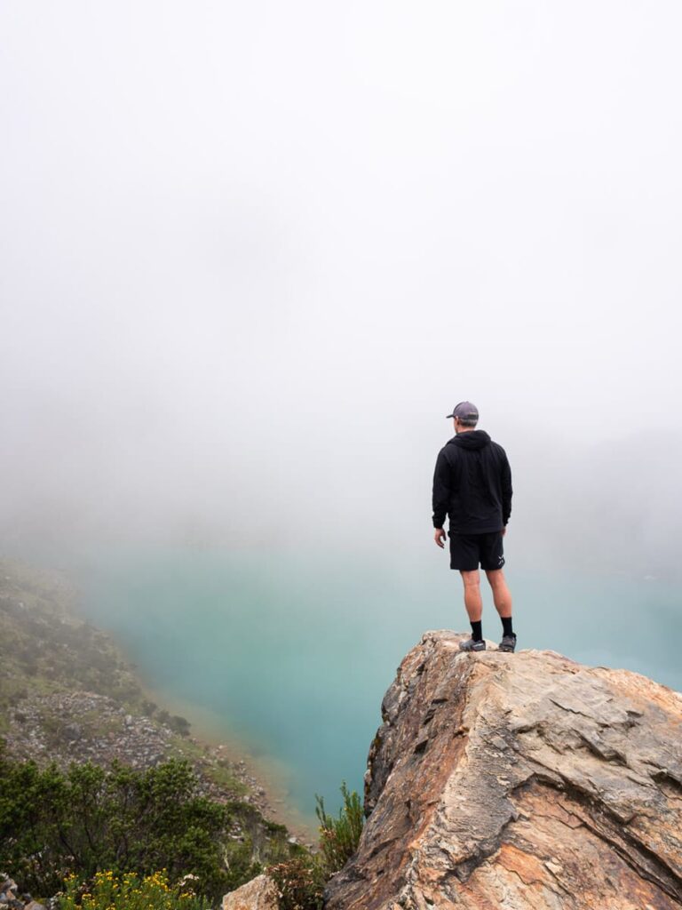 man looking out at humantay lake